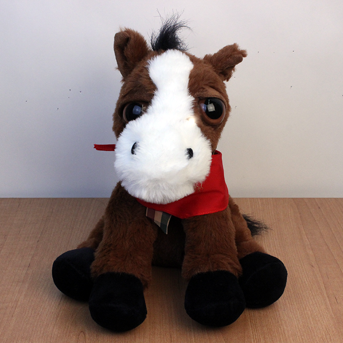 Brown and white horse plush with red bandana.
