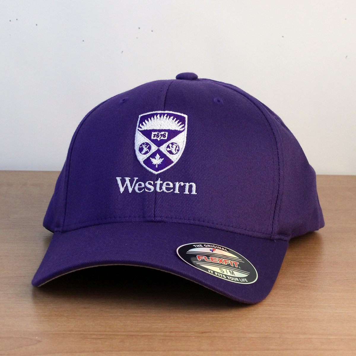 Purple ball cap with embroidered Western crest logo. Size SM/MD.