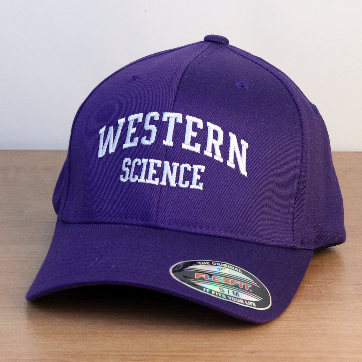 Purple ball cap with Western Science embroidered onto the front in white lettering. 