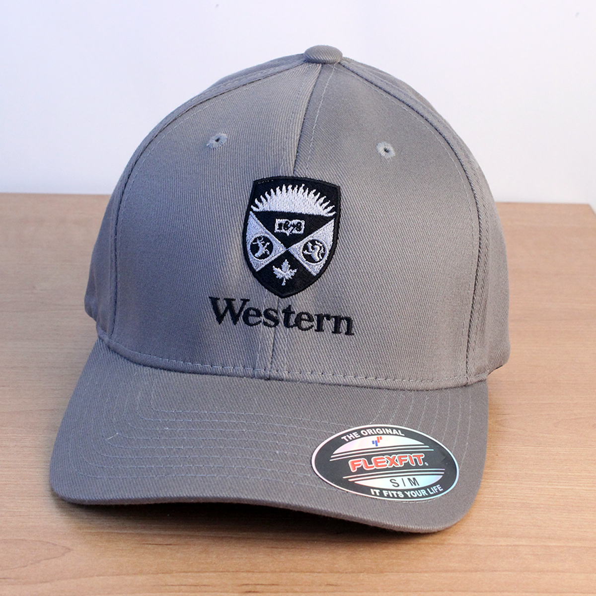 Grey ball cap with black and white embroidered Western Crest on front. 