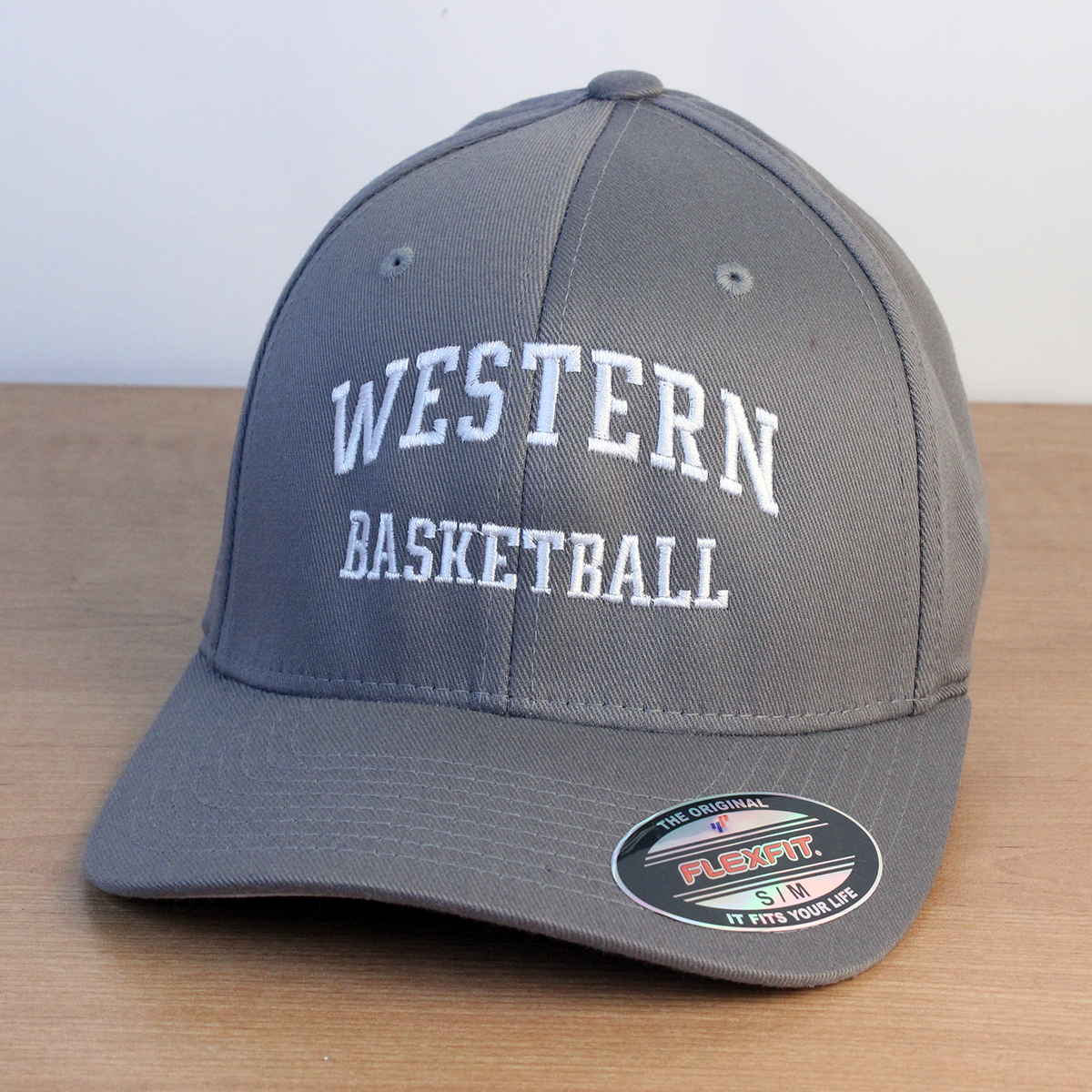 Grey ball cap with Western Basketball embroidered onto the front in white lettering.