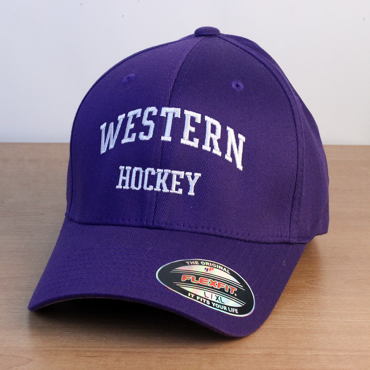 Purple ball cap with Western Hockey embroidered onto the front in white lettering. 