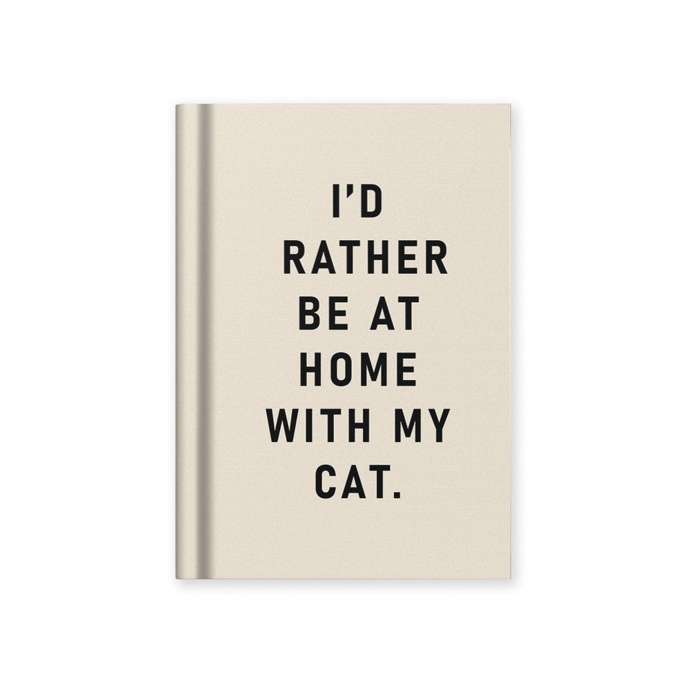 White notebook with black text 'I'd rather be at home with my cat'