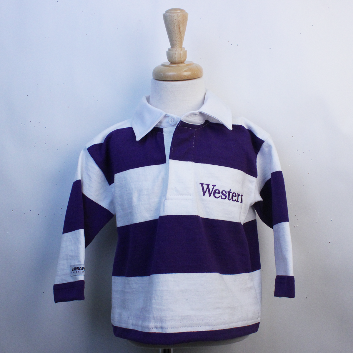 Toddler rugby long sleeve top with purple and white horizontal stripes. Western embroidered in purple lettering on left chest.