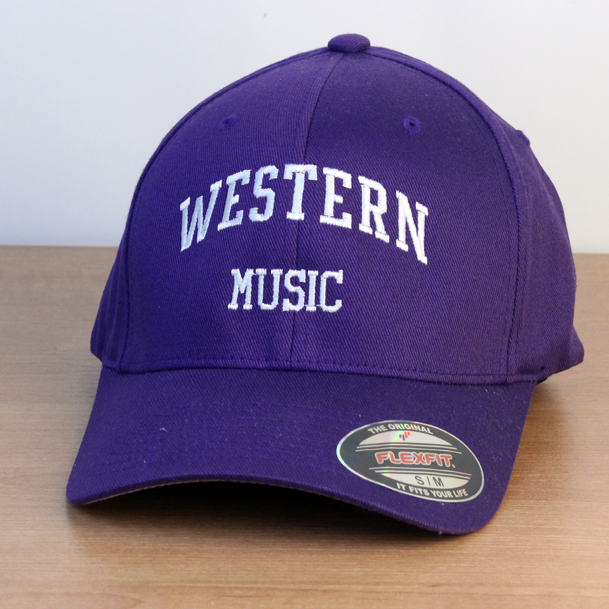 Purple ball cap with Western Music embroidered onto the front in white lettering. S/M sizing.