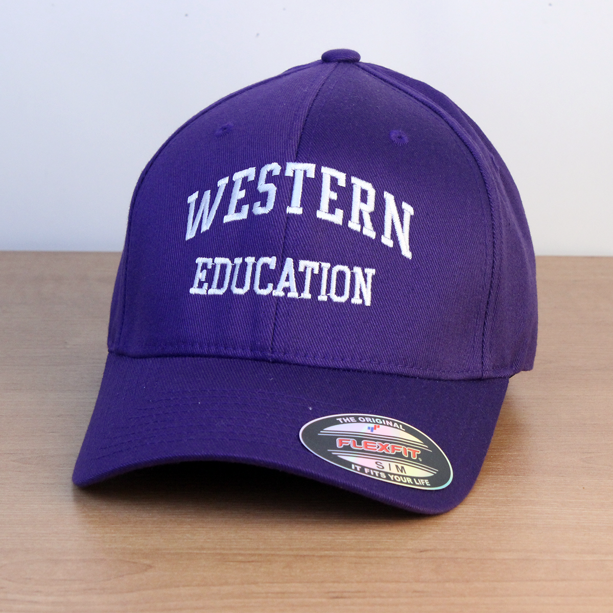 Purple ball cap with Western Education embroidered on the front. S/M sizing.