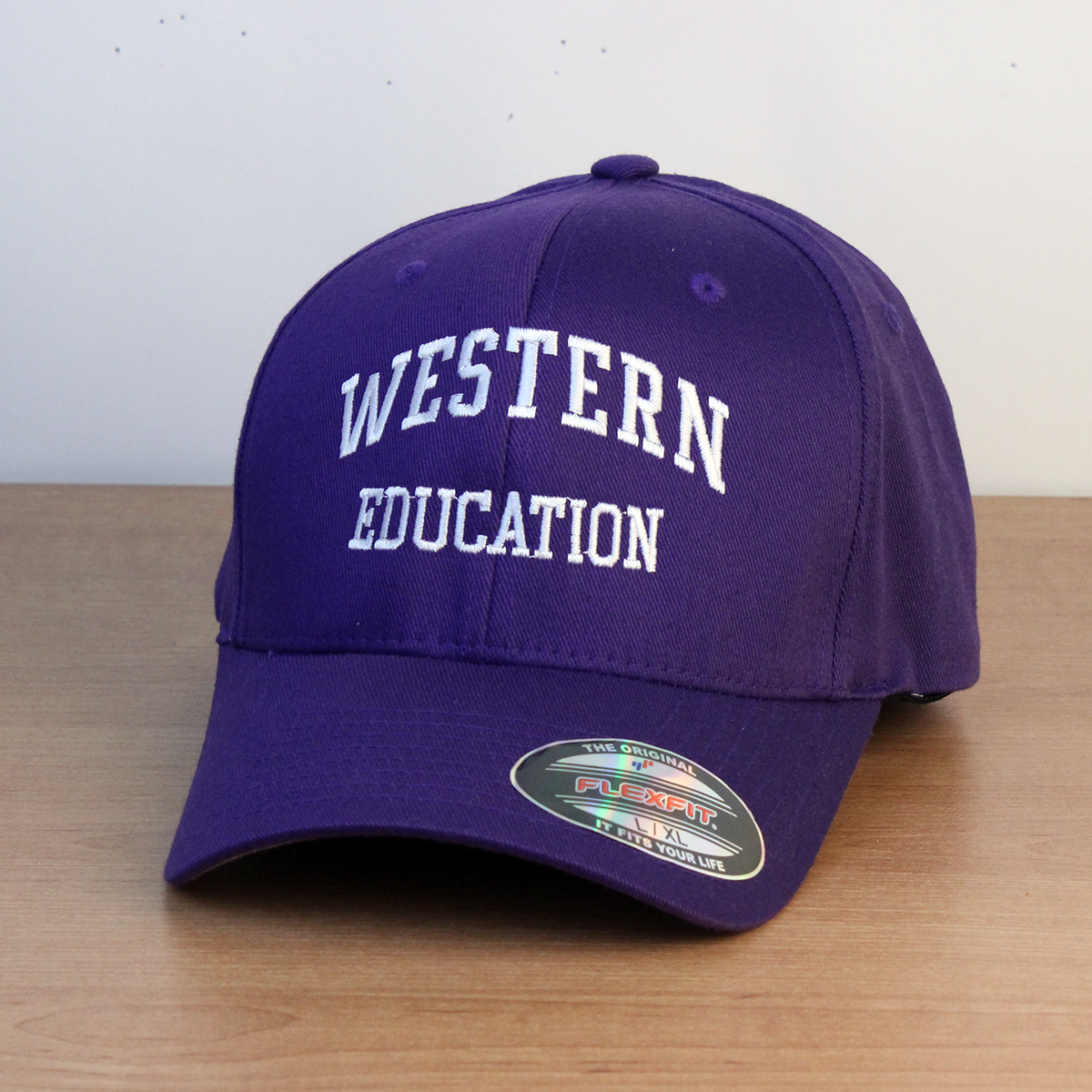 Purple ball cap with Western Education embroidered on the front. L/XL sizing.