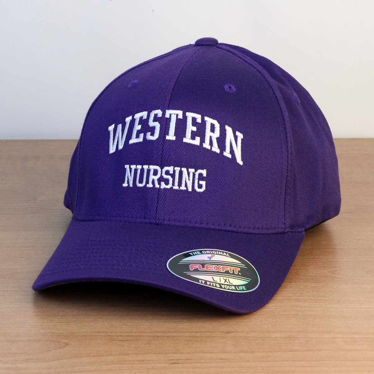 Purple ball cap with Western Nursing embroidered on the front. L/XL sizing.