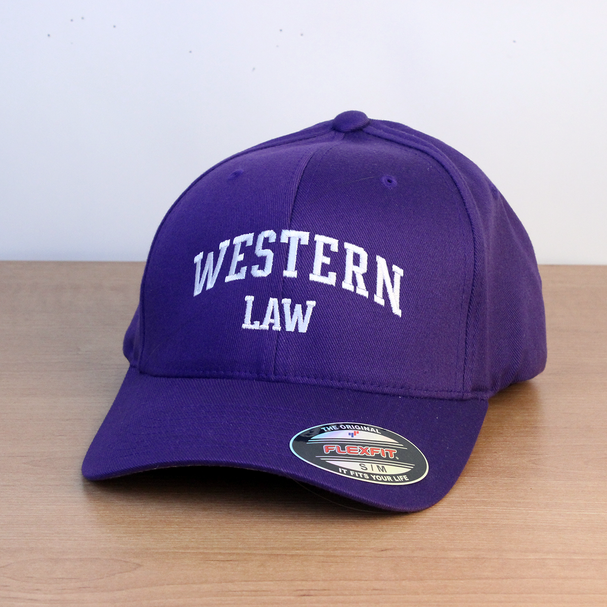 Purple ball cap with Western Law embroidered onto the front in white lettering. S/M sizing.