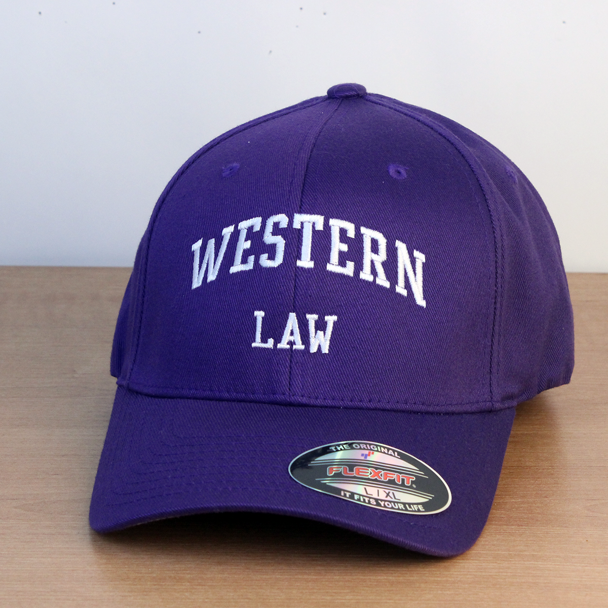 Purple ball cap with Western Law embroidered on the front. L/XL sizing.