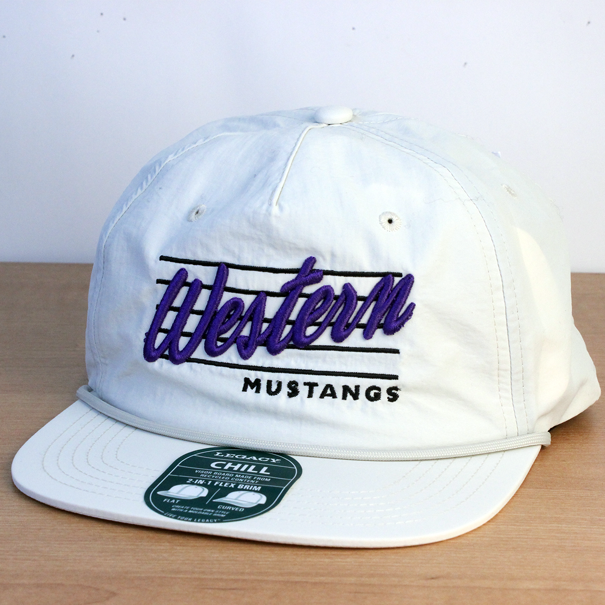 White flat brimmed cap with Western Mustangs embroidered script design on the front.