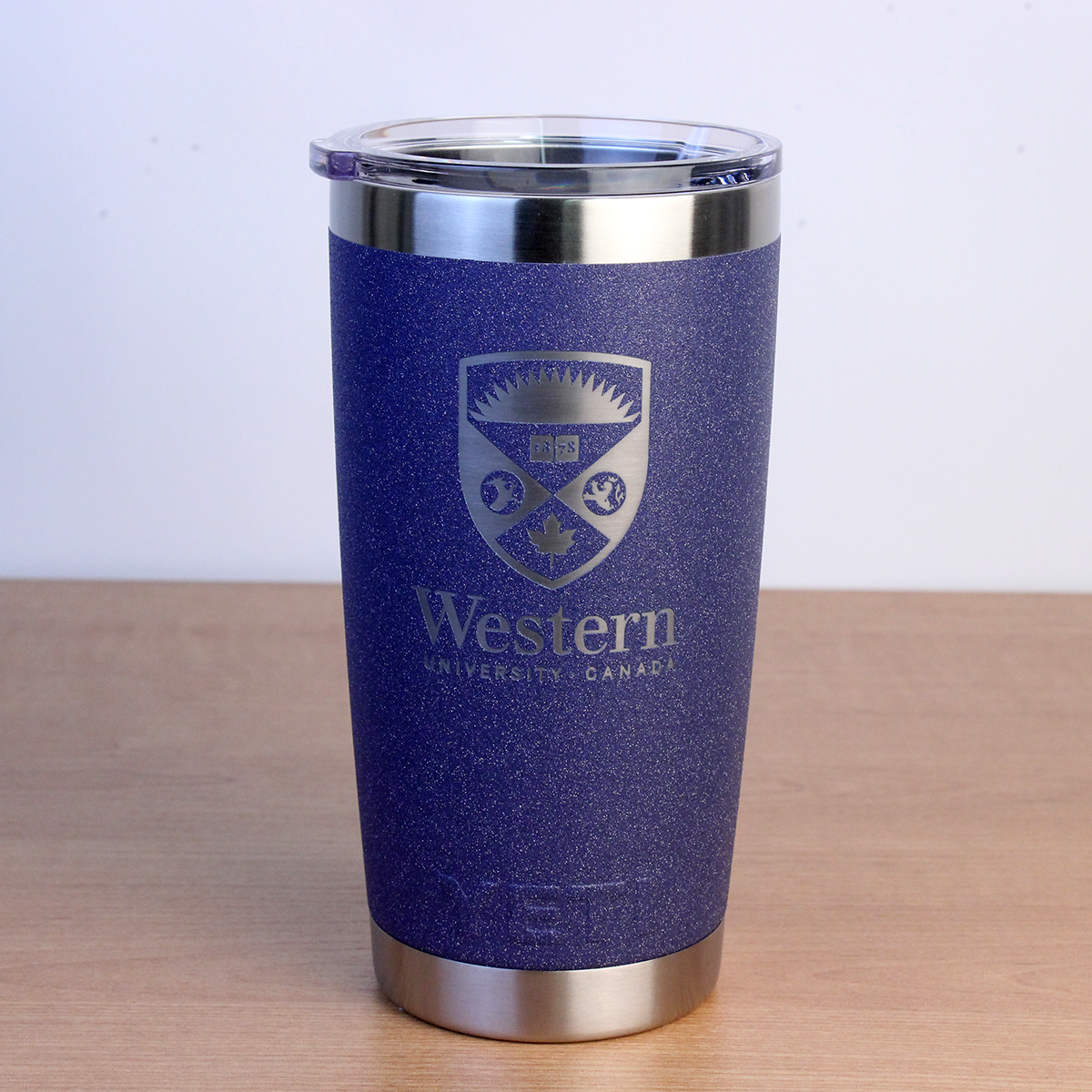 Purple speckled tumbler with the Western Crest logo engraved on the front.