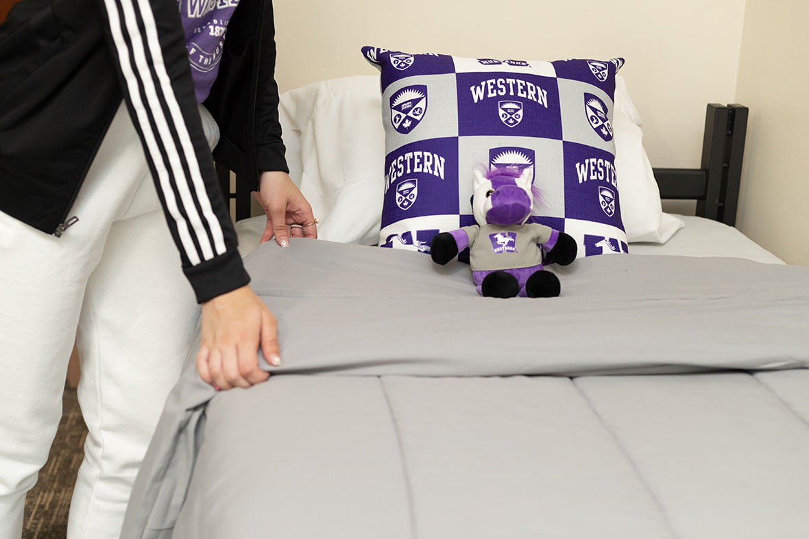 A person making a Western branded bed