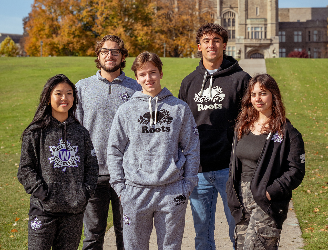 A group of people wearing roots branded attire