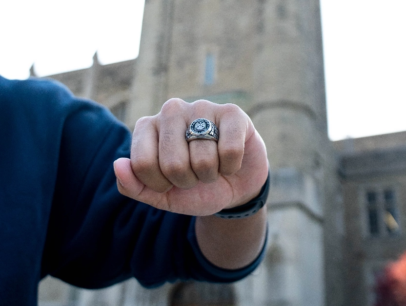 closed fist of student wearing a graduate ring