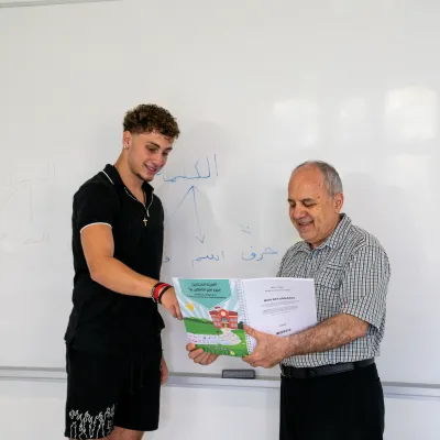 a student and a professor looking through a textbook