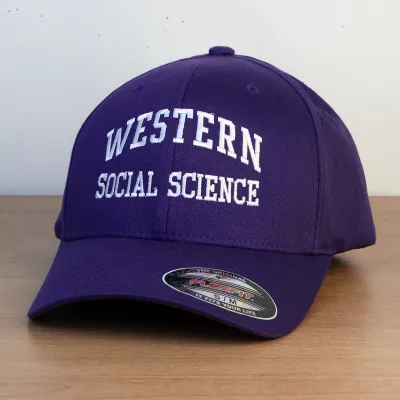 Purple ball cap with Western Social Science embroidered onto the front in white lettering. 