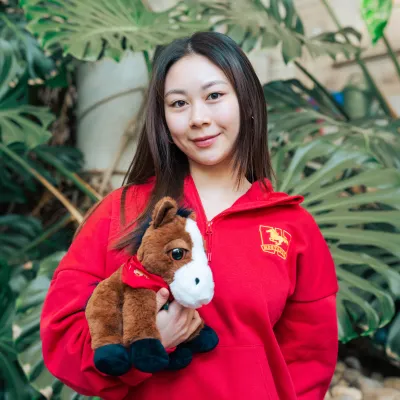A student holding a stuffed toy