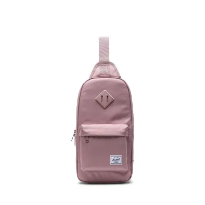 Muted pink Herschel heritage shoulder bag with front pocket.