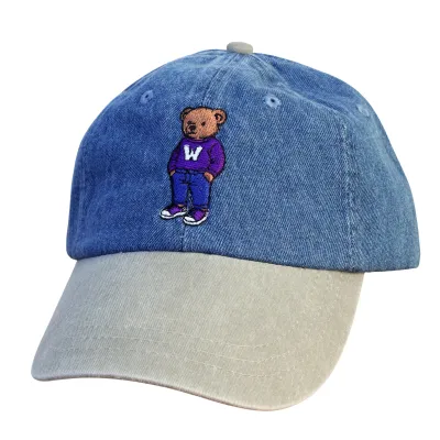 Denim and beige cap with a teddy bear graphic wearing a Western purple sweater embroidered on the front. One size.