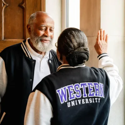 Husband looking into wifes eyes while wearing a western rugby jacket