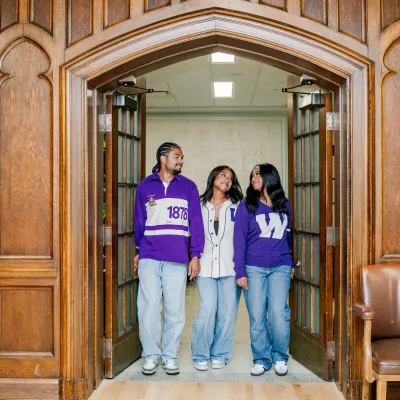 Siblings walking through an arched doorway