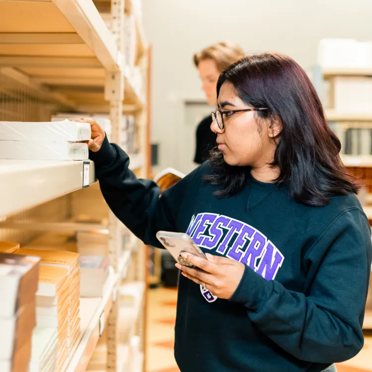 student browsing textboook at the bookstore