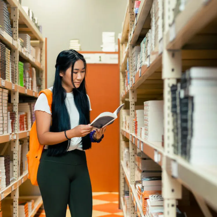 Student reading textbook in Bookstore