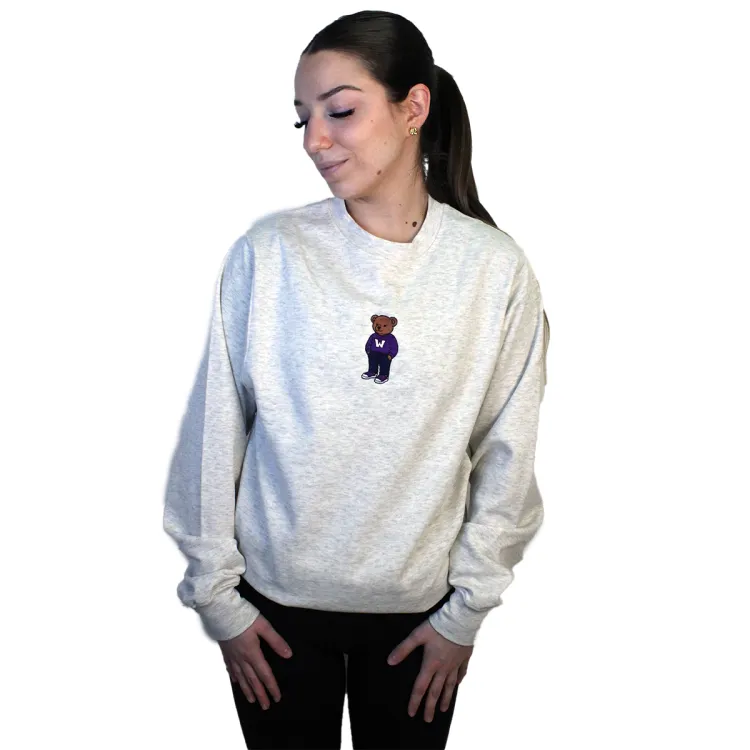 Light grey crewneck with embroidered brown teddy bear wearing a western sweater in the top middle of garment.