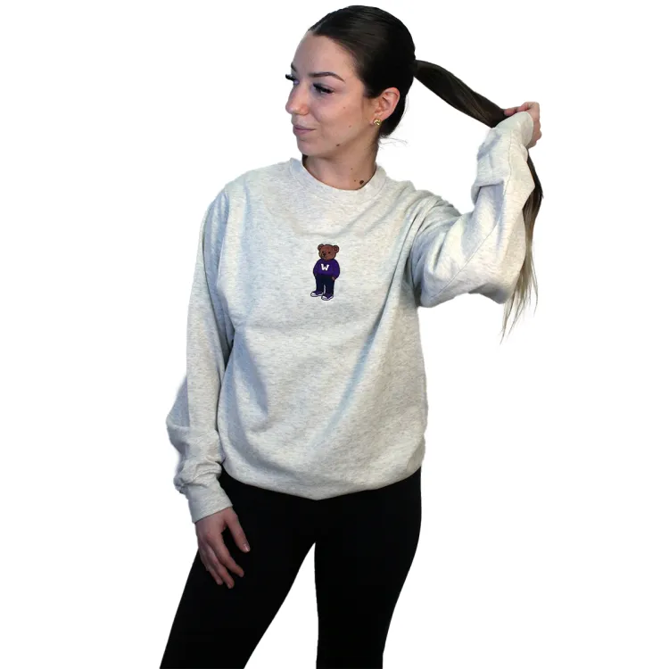 Light grey crewneck with embroidered brown teddy bear wearing a western sweater in the top middle of garment.