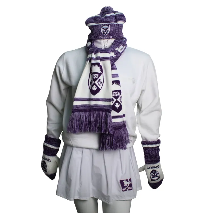 Purple and white toque with embroidered western crest logo paired with the purple and white crest scarf, purple and white crest mittens, white crew and white pleated skirt.