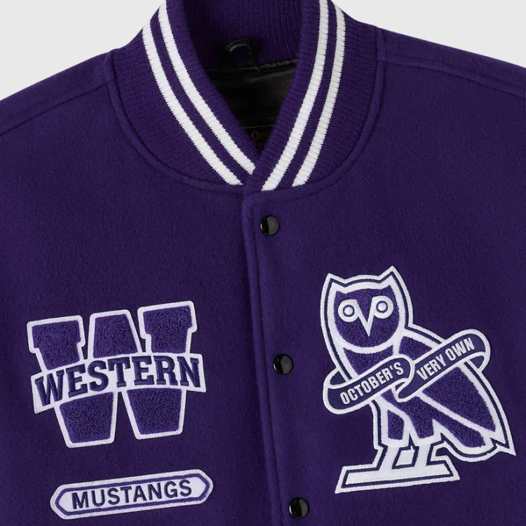 Close up of Varsity jacket showing Western W logo and OVO logo patches.