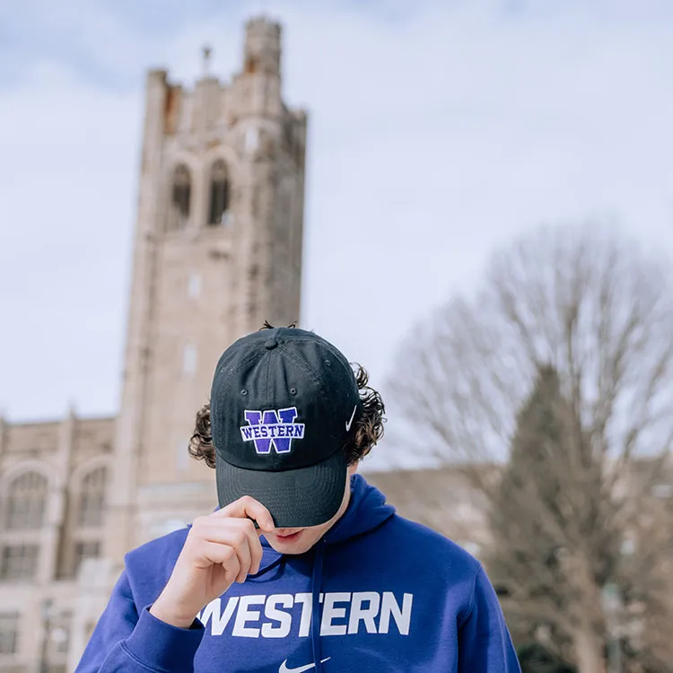 student wearing Nike Western hat and hoodie
