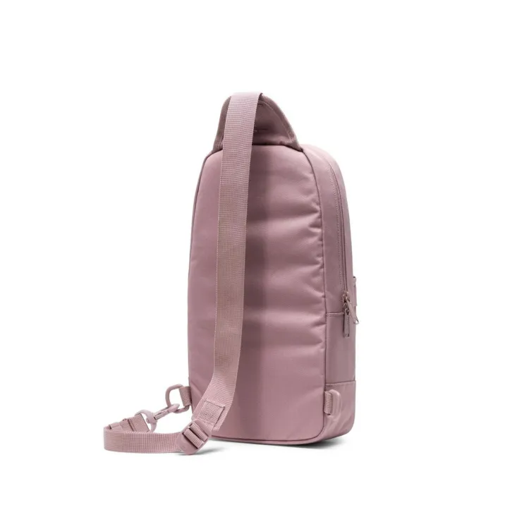 Muted pink Herschel heritage shoulder bag with front pocket.