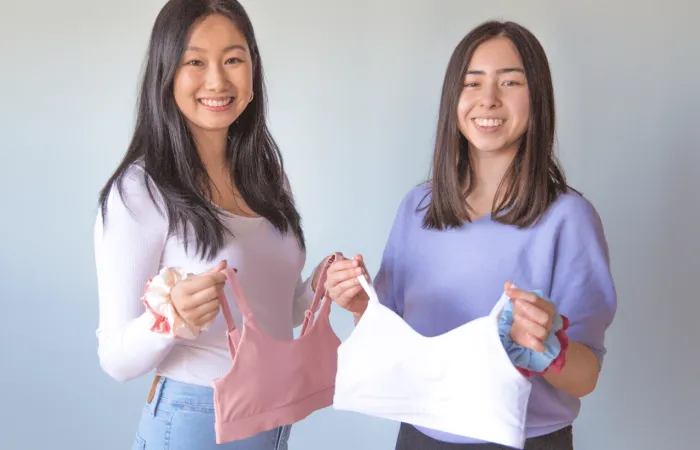 Apricotton founders holding up training bras