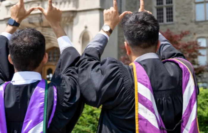 western students in purple graduation regalia