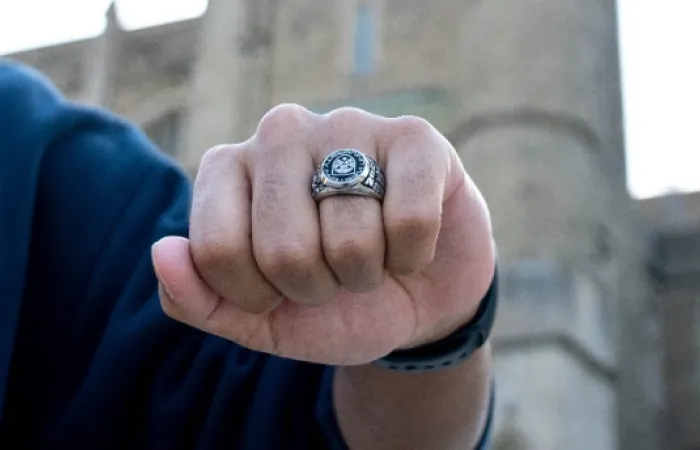 closed fist of student wearing a graduate ring