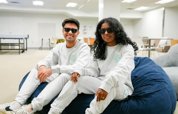 two students wearing residence merchandise crewnecks and joggers