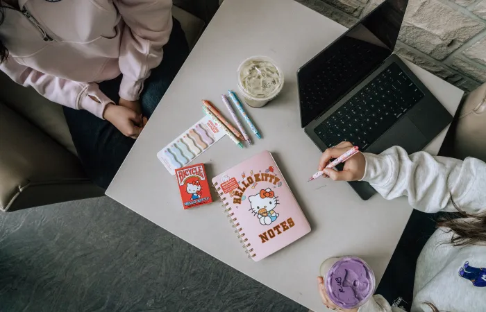 hello kitty notebook and accessories with a laptop
