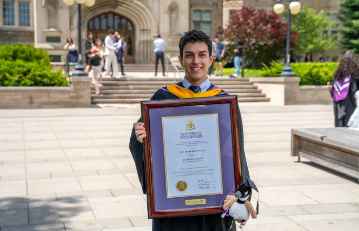 Graduate holding Framed Diploma