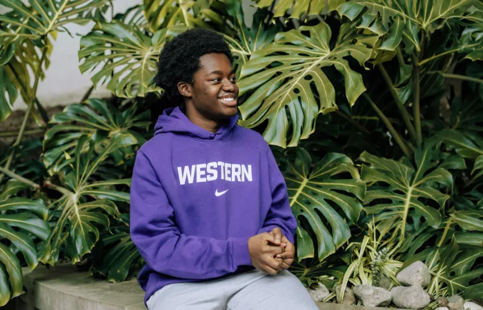 Man smiling in a Western Nike Sweatshirt