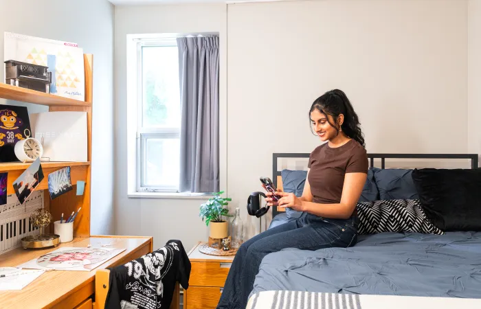 Girl sitting on the edge of a bed