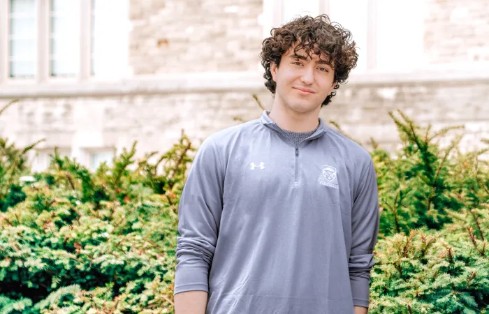 man standing outside in an under armor sweatshirt