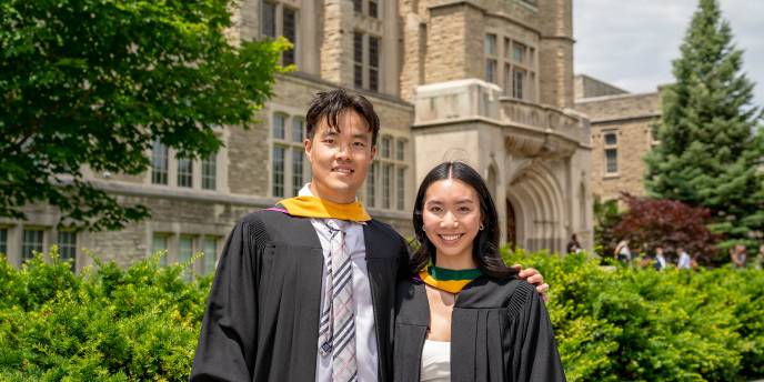 Two students wearing their Regalia