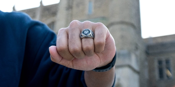 closed fist of student wearing a graduate ring