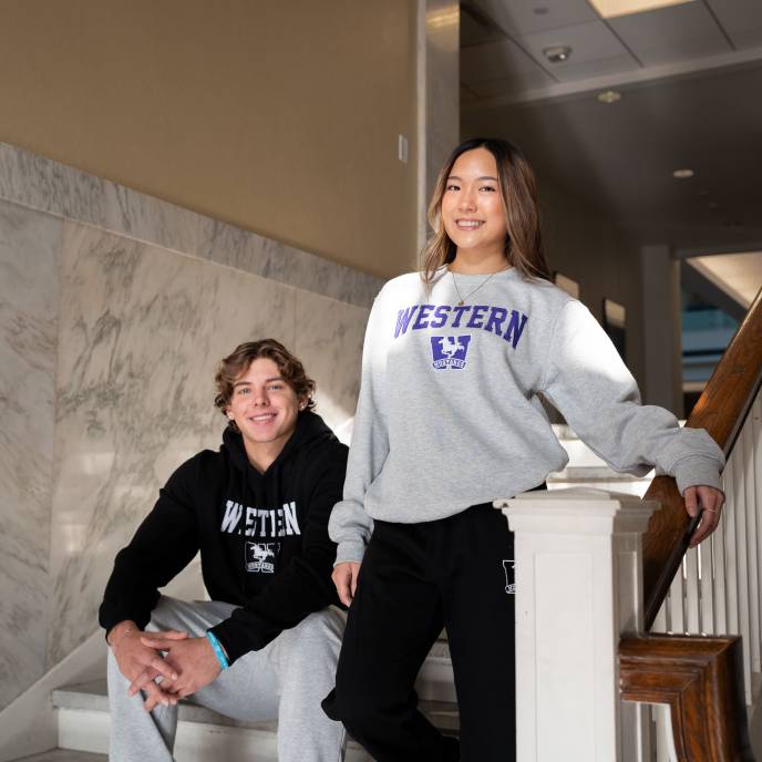 Two students wearing Western merch