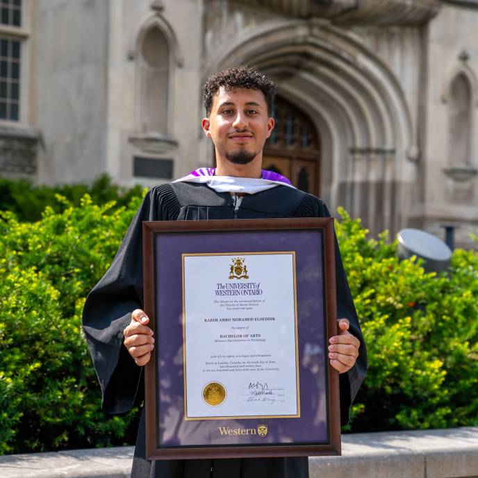 Person holding diploma frame